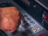 person holding gray and black control panel