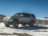 silver SUV on snow mountain