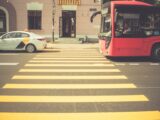 red bus near pedestrian lane