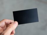 person holding black rectangular paper