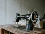 black sewing machine on brown wooden table