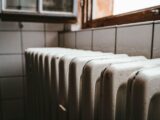 white radiator heater beside brown wooden window