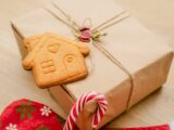 a present wrapped in brown paper with a gingerbread cookie in the shape of a