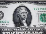 us dollar bill on black and white textile