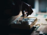 a close up of a person playing a board game