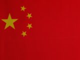a close up of a red background with yellow stars