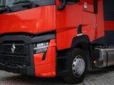 a large red truck parked next to a building