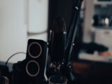 a microphone sitting on top of a table next to speakers
