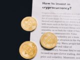 Gold Bitcoin coins on top of a cryptocurrency investment guide. High-quality finance and cryptocurrency image.