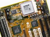Close-up of a vintage AMD K6 CPU on a retro motherboard showing intricate electronic details.