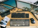 From above of desktop with multi monitors and keyboard with remove keycaps for cleaning