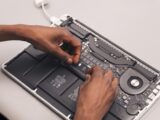 a person holding a laptop