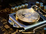 a bit coin sitting on top of a motherboard