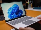 Hands holding a modern laptop with windows 11