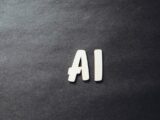 the word ai spelled in white letters on a black surface