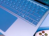 A close up of a laptop with a controller
