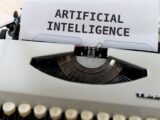 A close-up of a typewriter showcasing 'ARTIFICIAL INTELLIGENCE' on paper.