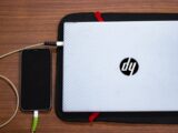 a laptop computer sitting on top of a wooden table