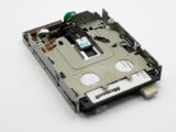 Close-up of a retro floppy disk drive with visible Microsoft label, showcasing historical technology.