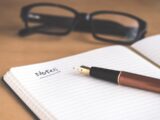 brown fountain pen on notebook