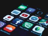 Detailed close-up view of a smartphone screen displaying various popular social media app icons.