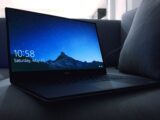 black Dell laptop on sofa