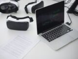 Modern workspace featuring laptop and VR headsets, ideal for tech themes.