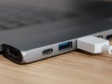 USB type c multiport adapter with plugged white cable connected to modern laptop