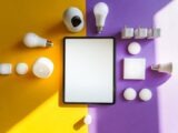 Top view of smart home devices and tablet on split yellow and purple background.