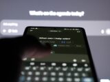 Person typing on smartphone with ai chatbot on screen.
