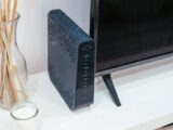 A sleek home technology setup featuring a router, glass decoration, and television.