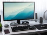 black computer keyboard beside silver imac