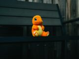 a stuffed toy sitting on top of a wooden bench