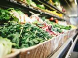 row of vegetables placed on multilayered display fridge