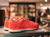a pair of red shoes sitting on top of a table