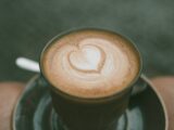 closeup photo of ceramic coffee mug with brown liquid inside