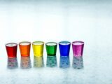 six assorted-color shot glasses