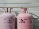 two pink Dynatemp 410 tanks on front of white wall