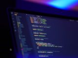 laptop screen displaying colorful code