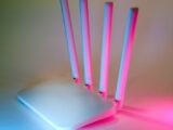 A sleek wireless router enhanced by vibrant neon lights, showcasing cutting-edge technology.