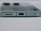 Detailed close-up of a smartphone's USB-C charging port and speaker grille, showcasing modern technology design.