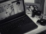 From above of contemporary netbook placed near modern computer game mouse and frame with photo
