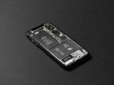 High-resolution image of a smartphone showcasing its internal components on a dark surface.