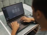 A person using a laptop to interact with AI technology indoors during the day.