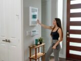 a woman standing in front of a wall mounted light switch