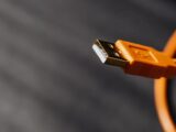 Detailed shot capturing an orange USB cable connector on a contrasting background.