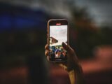 A person taking a picture with a cell phone