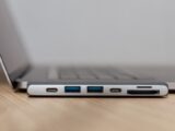 Space grey type c USB hub with multiple different ports connected to laptop