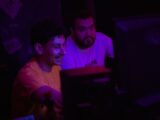 Two men looking at a computer screen